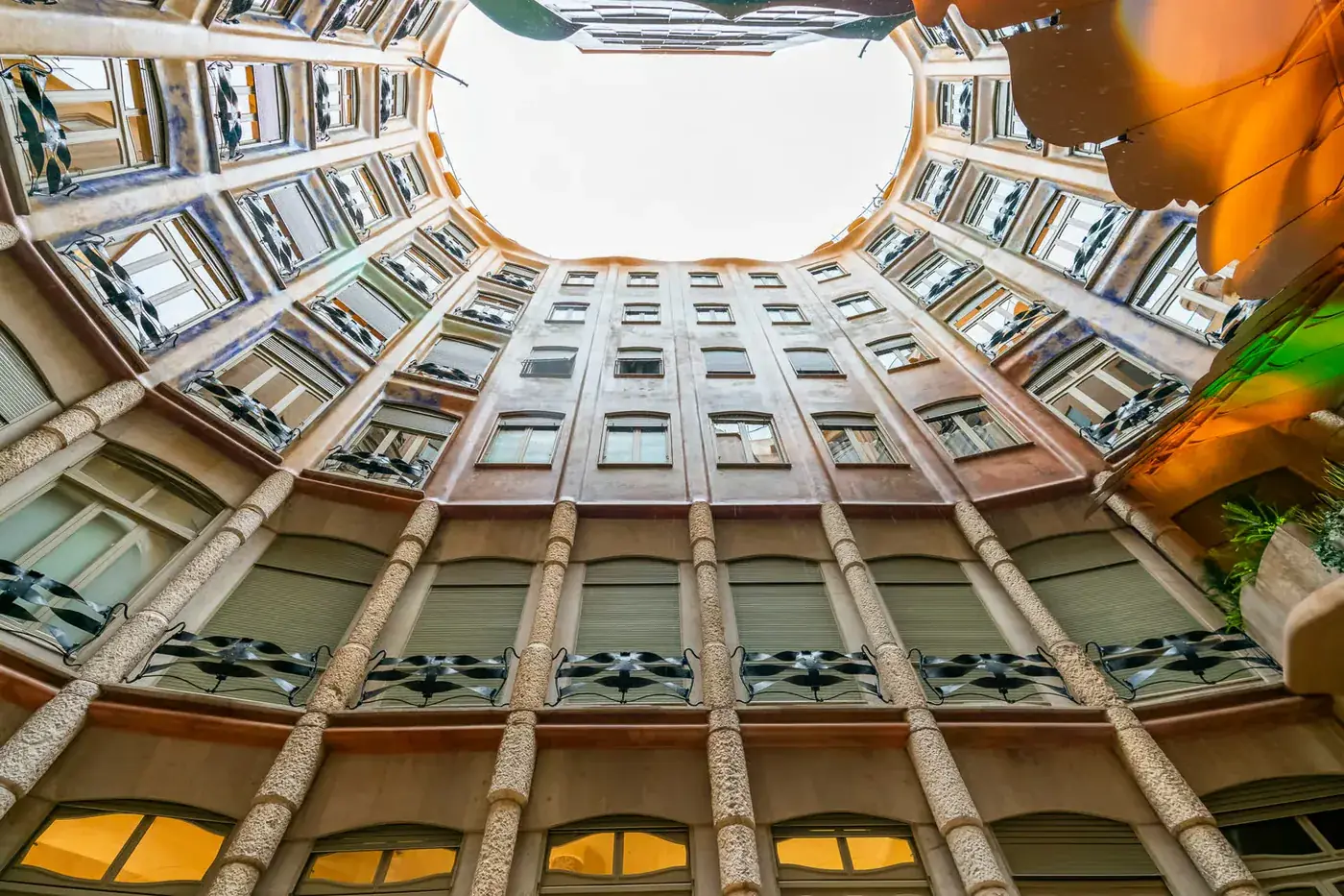 The light-filled inner courtyard rises through Casa Mila, with balconies around its central opening.
