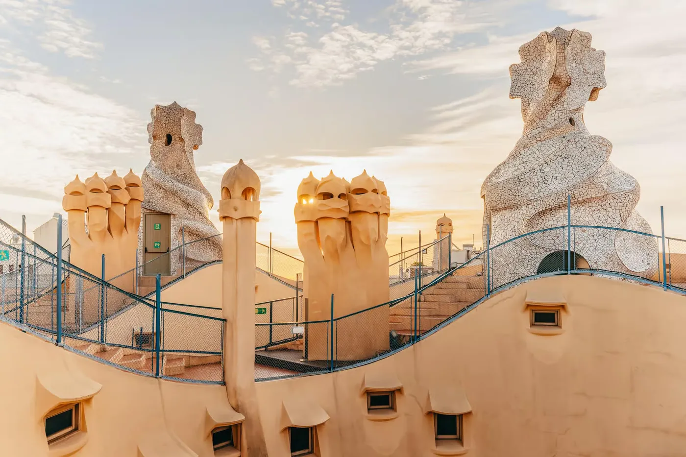 Morning light falls across La Pedrera rooftop chimneys.
