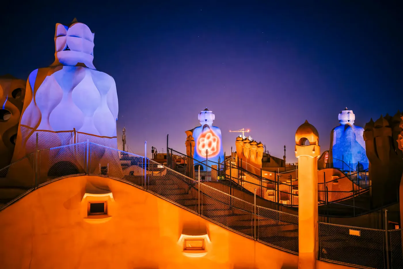Violet and orange projections light the rooftop during the evening audiovisual show.